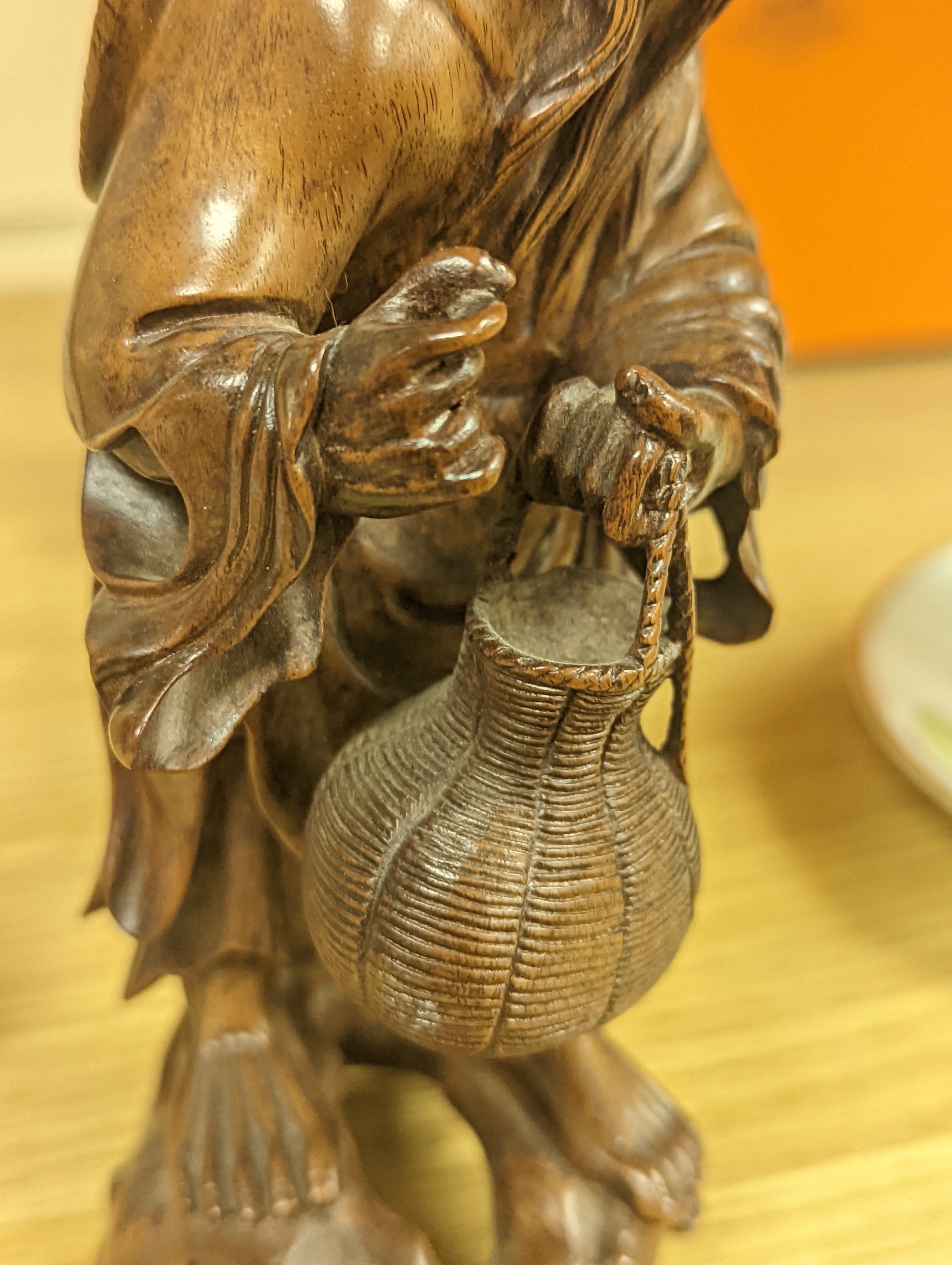 Two Chinese hardwood figures of a fisherman and a old man holding peaches 16cm